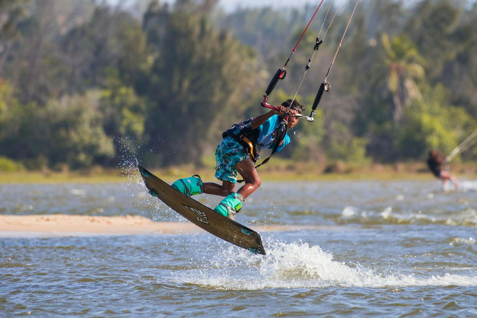 a boy wakeboarding at the beach